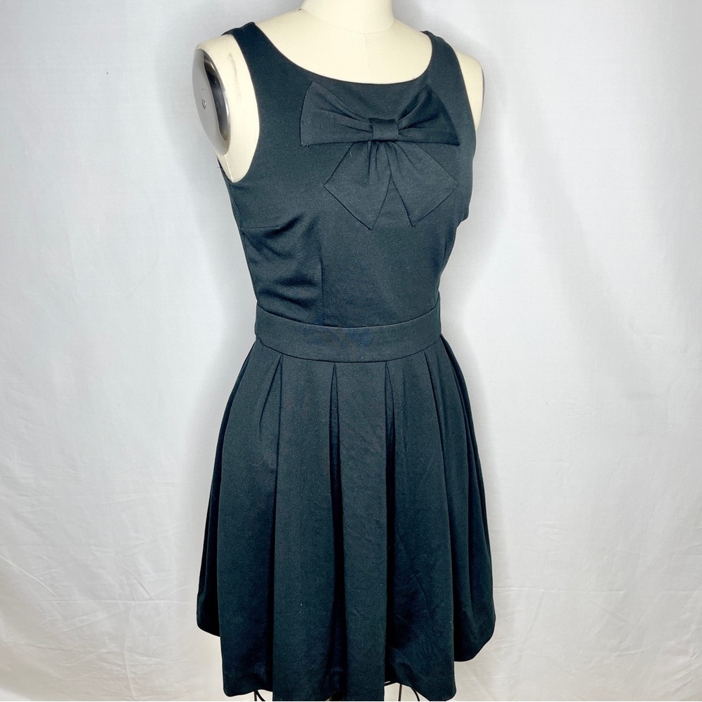 Lauren Conrad Black skater dress with sewn large bow design and pleated bottom